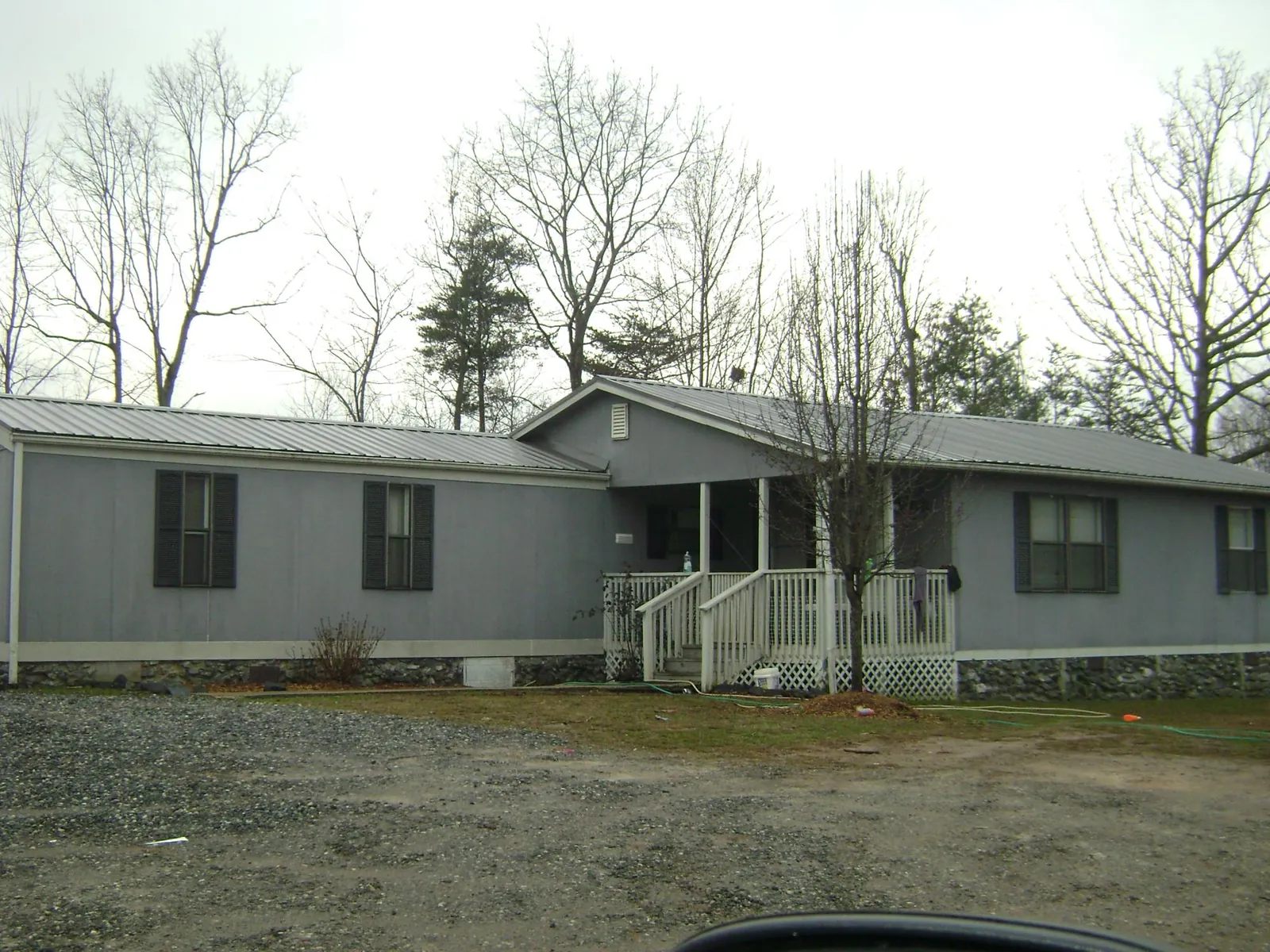 Metal roof over a manufactured home with a covered front porch in Scarville